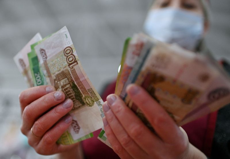 Rouble tumbles to record low as West steps up Russian sanctions